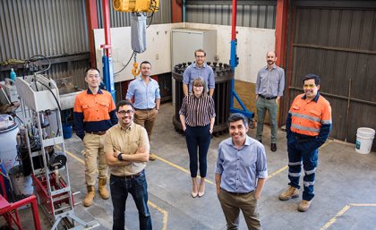 UQ blasting and fragmentation technology team standing socially distanced in a lab
